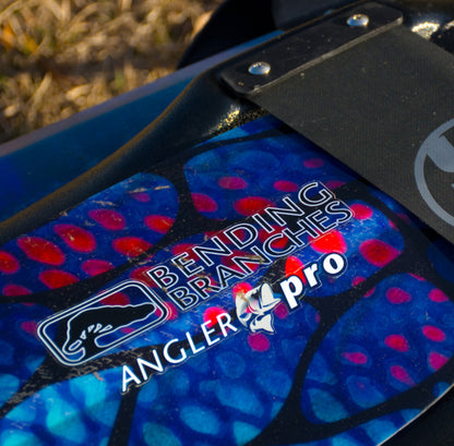 Close-up of a fishing rod with 'Bending Branches Angler Pro' branding on a blue and red patterned background.