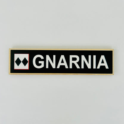 GNARNIA logo on a black rectangular sign with white text against a light gray background