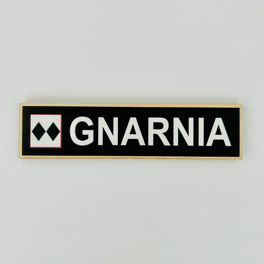 GNARNIA logo on a black rectangular sign with white text against a light gray background