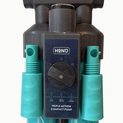 HONU triple action compact pump with teal nozzles on a white background